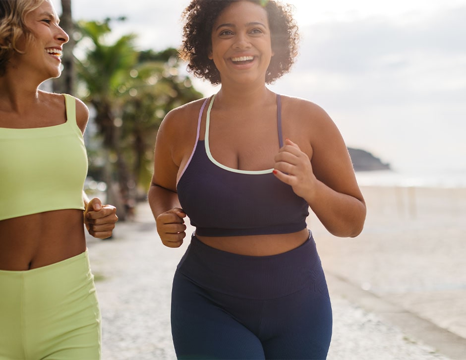 Two women running by the beach