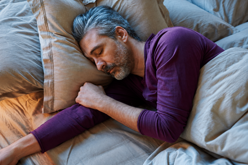 Older man asleep in bed