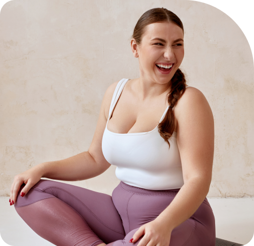 woman sitting down on yoga mat