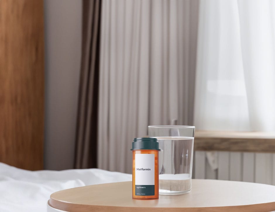 Metformin bottle on a table with a glass of water