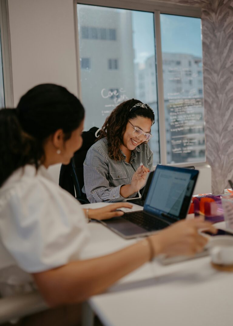 two people reviewing in laptop