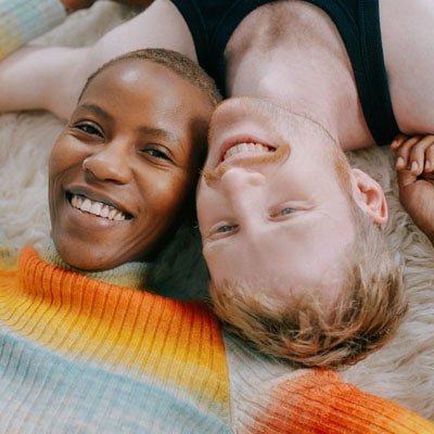 Couple laying side by side smiling